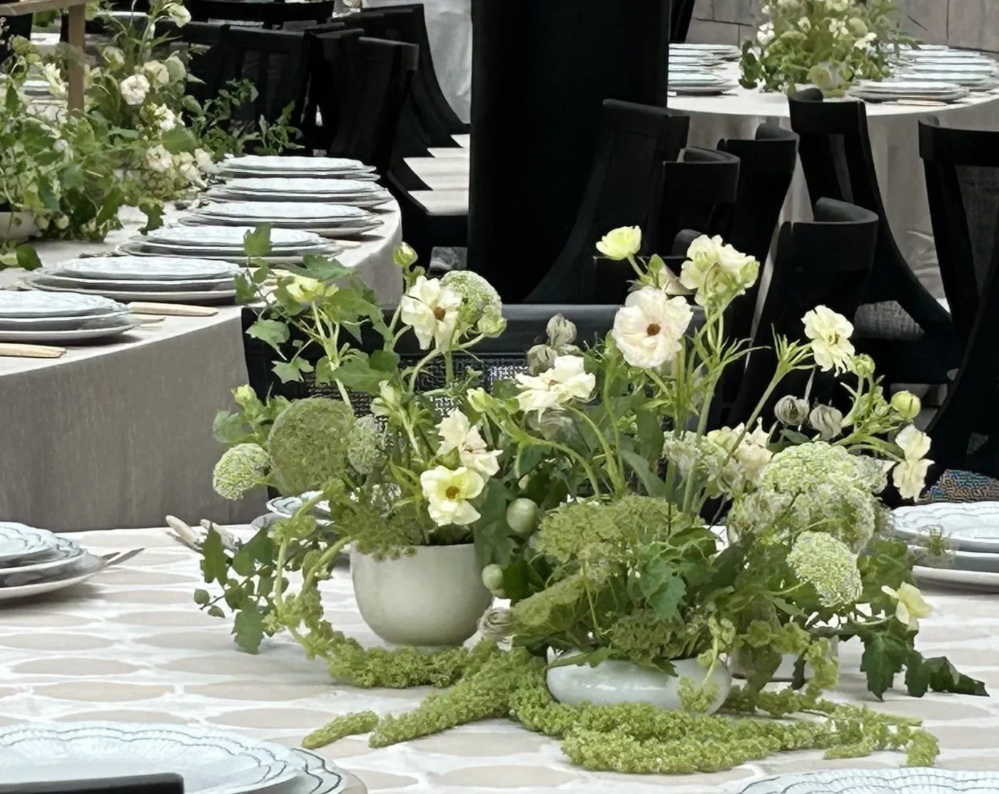 Green and white centerpieces set along an event table