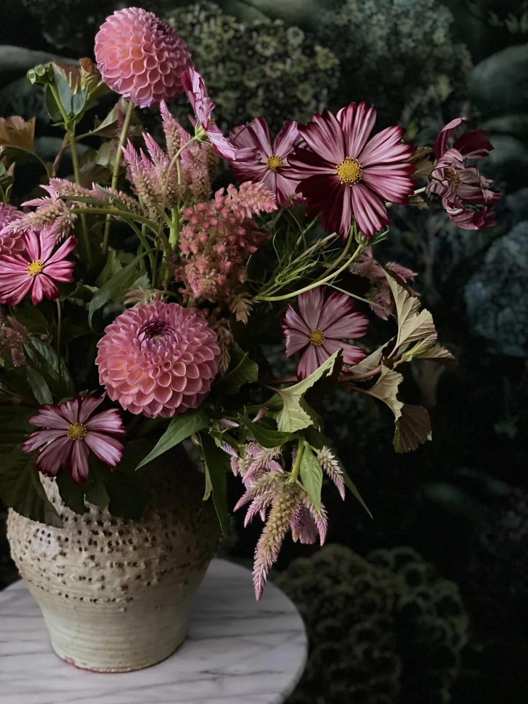 Pink dahlias and cosmos in a stoneware vase